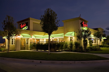 A photograph of a Perko's restaurant at night.